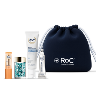 RoC skincare products (Revive + Glow Eye Balm, Hydration+ Serum Capsules, Even Tone + Lift Moisturizer SPF 30, Lip Volumizer) with a navy holiday cosmetic bag on a white background.