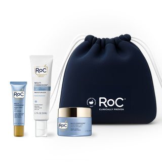 RoC skincare products (Even Tone + lift. EYE cream, even tone + lift MOISTURIZER SPF, even tone + lift night cream) with a navy holiday cosmetic bag on a white background