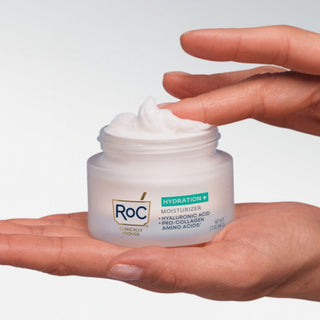 Hands holding a jar of Roc Hydration+ Moisturizers against a white background