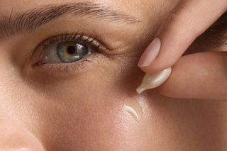 Close-up of a woman applying Retinol Correxion Line Smoothing Night Capsule to her face