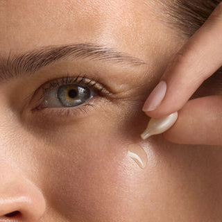 Close-up of a person applying Retinol Correxion Line Smoothing Night Serum Capsules to their face