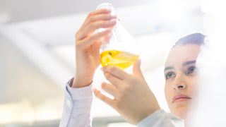 Person holding a yellow container with a blurred background