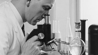 Person using a microscope in a laboratory setting