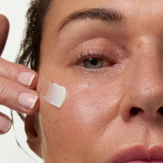 Close-up of a person applying cream to their face