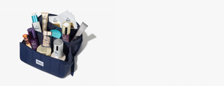 A navy blue MRC travel toiletry bag filled with assorted skincare and beauty products, photographed on a clean white background with a soft shadow.