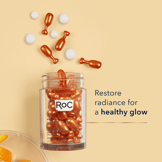 Stylized Image of MULTI CORREXION® Revive + Glow Vitamin C Night Serum Capsules falling out of jar with caption "Restore radiance for a healthy glow"